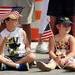 Joey Eiler, 8, sits with his sister Cara, 5, both of Saline, as they watch the 23rd Annual Ann Arbor Jaycees Fourth of July Parade on Thursday, July 4, 2013 on South State Street in downtown Ann Arbor. Melanie Maxwell | AnnArbor.com